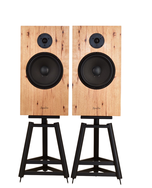A pair of DynaTen J25 Special speakers with a hickory finish, vintage wheat grills, and displayed on stands.