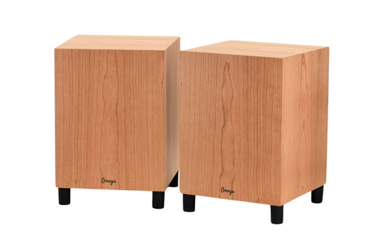 Two Omega DeepHemp 8 subwoofers made of hemp with a cherry wooden finish, positioned upright and side by side.