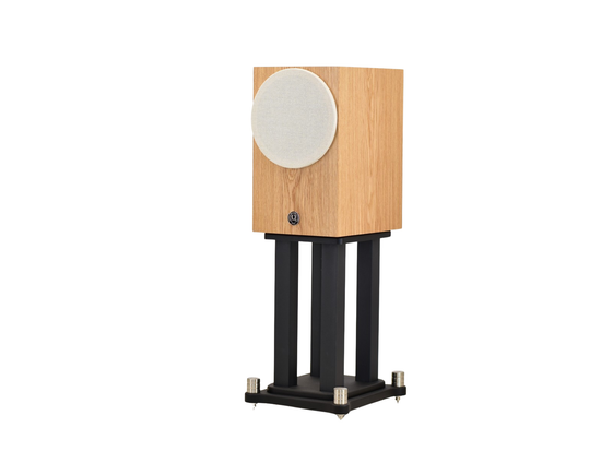 omega Speakers compact eight monitor to the left with tan round grill on stand in white oak wood finish